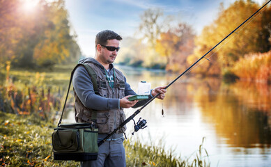 Angler choosing bait while trying to catch a trophy fish on the river. Sport and recreation concept