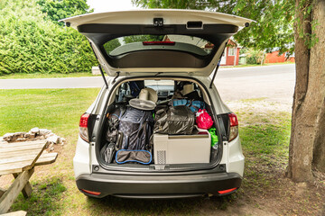 Travel on car with camping luggage packed at the full car trunk, holiday concept. Outdoor...