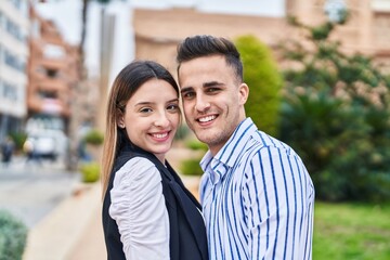 Fototapeta premium Man and woman couple smiling confident standing together at park