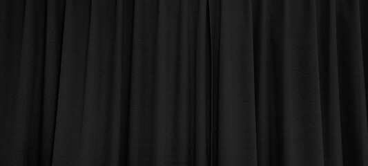 close up view of dark black curtain in thin and thick vertical folds made of black out sackcloth...