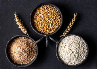 Cups of grains, bran and flour
