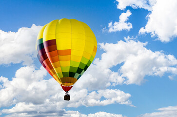 Colorful hot air balloon flying over blue sky