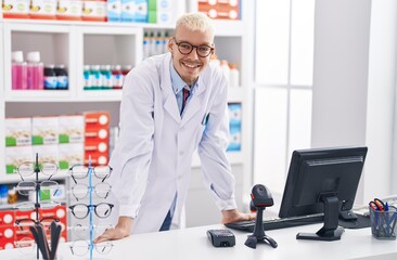 Naklejka na ściany i meble Young caucasian man pharmacist smiling confident standing at pharmacy