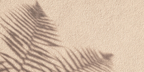 Tropical palm branch with shadow on a beige concrete wall, natural texture. Abstract background. Copy space. Summer grunge wallpaper with minimal concept. Mockup, overlay effect and natural lightning.