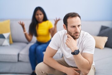 Man and woman interracial couple arguing at home