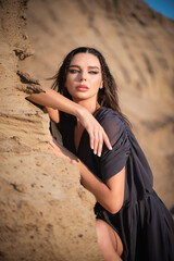 A young beautiful girl in the dress in the sand desert concept.