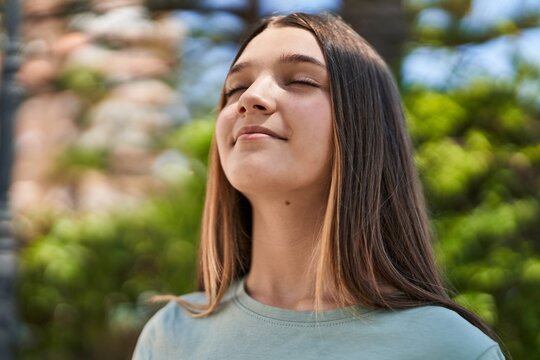 Adorable girl smiling confident breathing at park