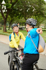 Friends deciding where to ride on bicycles