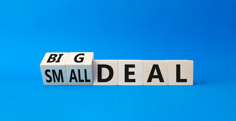 Big deal and small deal symbol. Turned cubes with words Big deal and small deal. Beautiful blue background. Business concept. Copy space