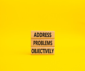 Address Problems Objectively symbol. Wooden blocks with words Address Problems Objectively. Beautiful yellow background. Business and Address Problems Objectively concept. Copy space.