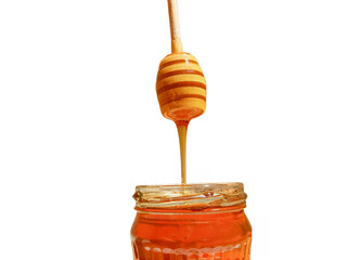 polyflora bee honey flowing into a jar from a wooden spoon. The concept of beekeeping