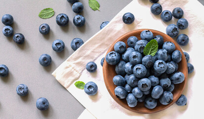 Bowl plate blueberries blueberry with leaves on kitchen table top view
