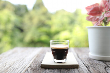 Glass coffee cup and notebook with plant pot