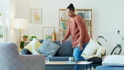 Timelapse of a young woman doing laundry, housework and other chores at home. Female neatening up and keeping the living room clean while spring cleaning. Keeping her house neat, tidy and hygienic