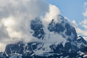 Fototapeta na wymiar Beautiful mountains landscape. Clouds covering the top of Ushba mountain. Svaneti Geogria