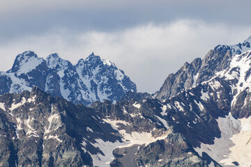 Beautiful snow covered mountains with in the fog and dramatic clouds.