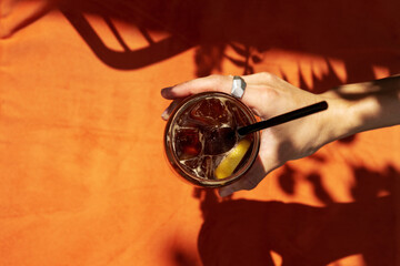 Holding fresh and iced cocktail with caffeine