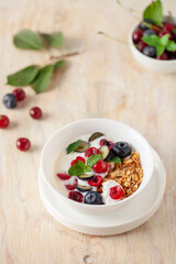 Cherry and blueberry granola with yogurt. Healthy food, diet breakfast.