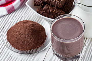 chocolate cocoa milk powder on a white wooden rustic background