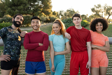 group of handsome multiracial sporty friends smiling looking at camera after exercising