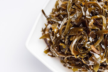 seaweed salad on a white acrylic background
