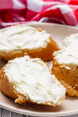 baguette cream cheese sandwich on a white background