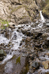 the mountain river flows quickly over the stones