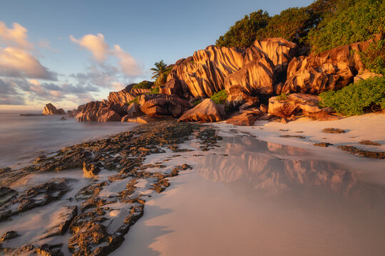 Sunrise on a tropical beach with granite rocks in Seychelles