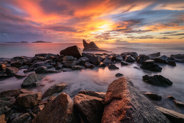 Dramatic sunset on the beach with granite rocks in Seychelles