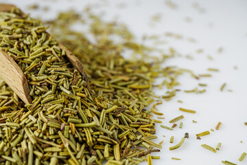 fragrant dried rosemary on a white acrylic background