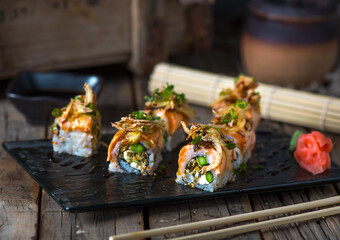 Obraz premium SALMON SKIN MAKI served in a dish isolated on wooden background side view