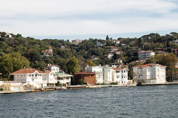 Fototapeta na wymiar View of historical, traditional mansions by Bosphorus in Kanlica area of Asian side of Istanbul. It is a sunny summer day. Beautiful travel scene.