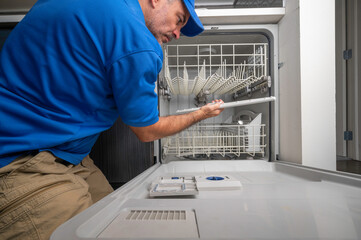 Appliance Technician Repairing a Dishwasher