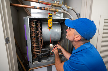 Hvac Technician checking voltage on a blower motor
