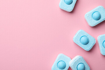 Water softener tablets on pink background, flat lay. Space for text