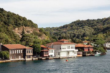 Fototapeta na wymiar View of historical, traditional mansions by Bosphorus in Kanlica area of Asian side of Istanbul. It is a sunny summer day. Beautiful travel scene.
