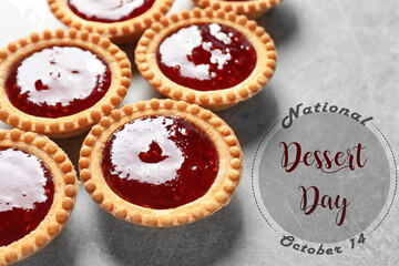 National Dessert Day, October 14. Tasty tartlets with jam on light grey table