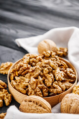 dried walnuts on a black rustic wooden background