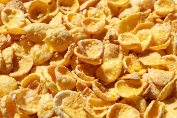 Crispy corn flakes as background, closeup view