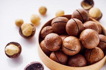fresh macadamia nuts on a white acrylic background