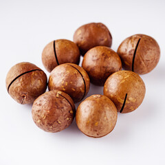 fresh macadamia nuts on a white acrylic background