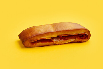 Lanche misto traditional portuguese sandwich with cheese and chorizo. Tasty breakfast over yellow background.