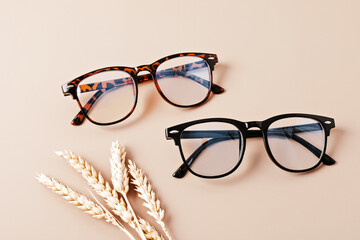 Stylish eyeglasses over pastel background. Optical store, glasses selection, eye test, vision...