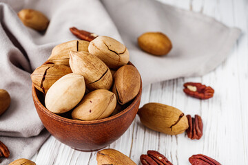 delicious fresh pecans on a white wooden rustic background