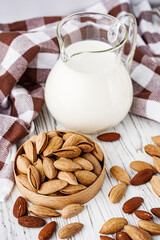 almond milk on a white wooden rustic background
