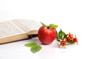 Red apples, Torah book with pomegranate flowers and fruits on white background, Rosh Hashanah...