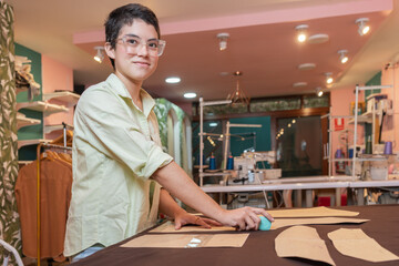 Happy woman working in a sewing workshop