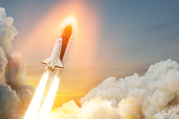 Spaceship lift off. Space shuttle with smoke and blast takes off into space on a background of...