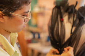 Focus on the face of a woman working in a sewing workshop