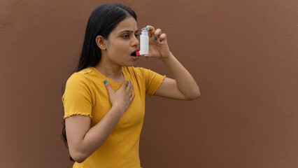 Asthmatic patient catching inhaler having an asthma attack. Young woman having asthma, chronic...